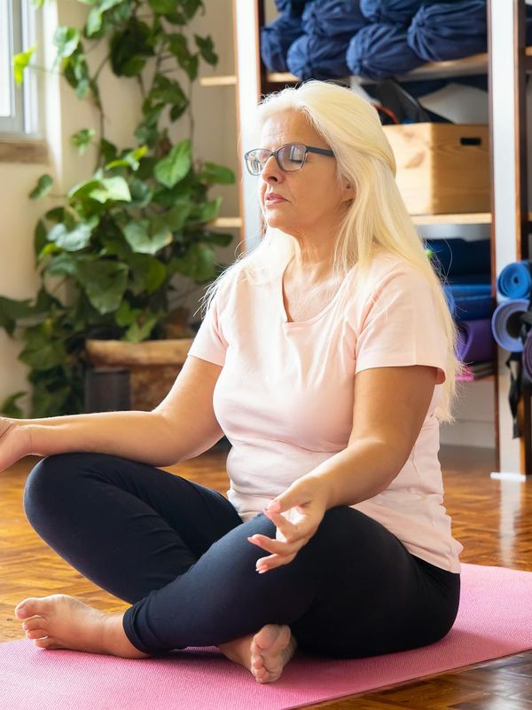 A person in deep concentration during a balancing yoga pose.
